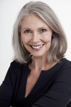 A woman with gray hair smiling for the camera.